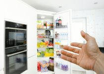man pointing to fridge in UAE